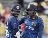 Sri Lanka's Lahiru Thirimanne (L) and Kumar Sangakkara hold a mid-pitch discussion during their Cricket World Cup match against England in Wellington, March 1, 2015. REUTERS/Anthony Phelps