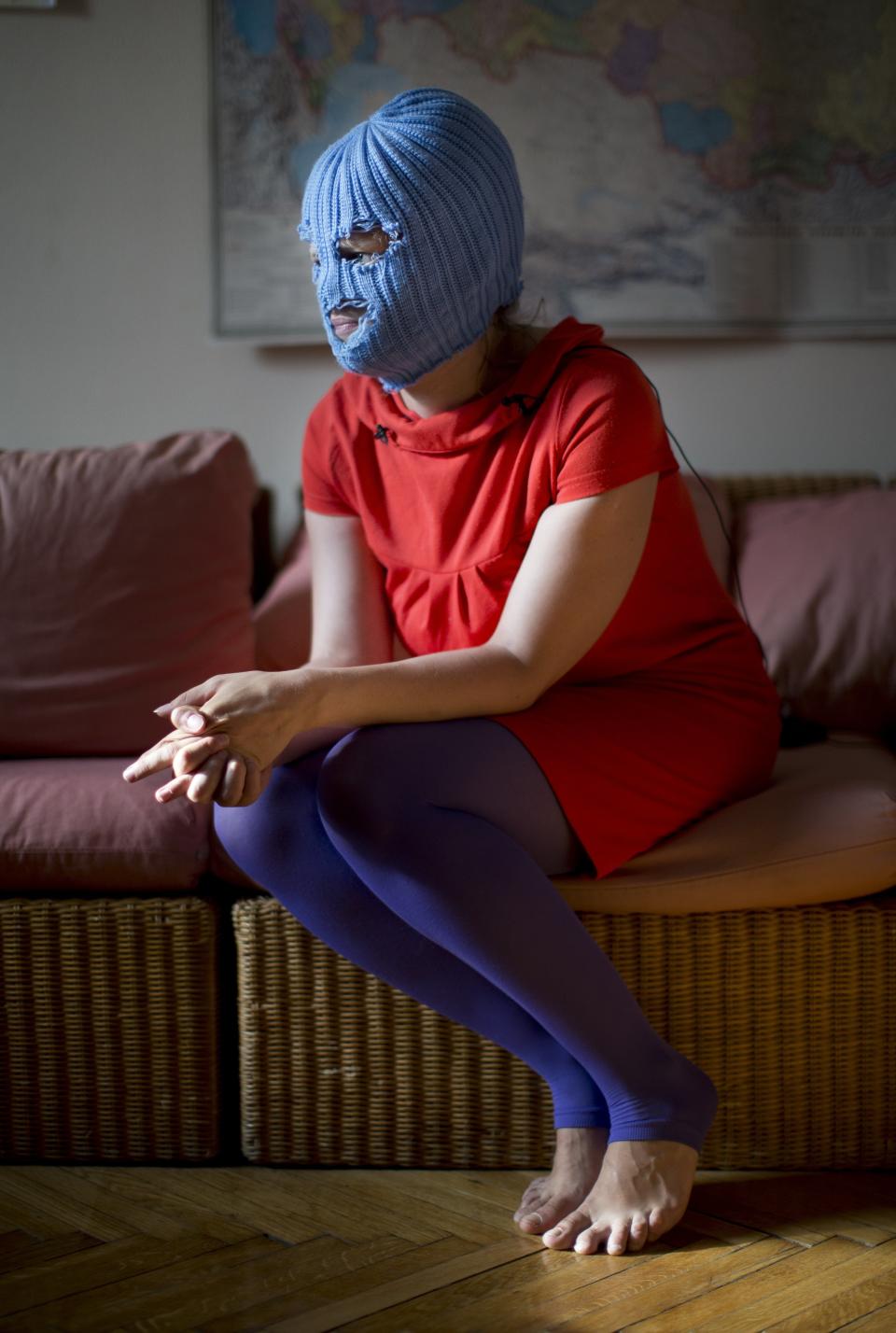 A Russian punk band Pussy Riot member, who gave only her stage name of Grelka, wearing a blue balaclava, speaks to the media in Moscow, Tuesday, July 16, 2013. (AP Photo/Alexander Zemlianichenko)