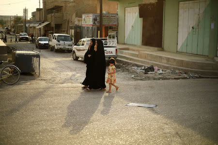 Women walk in the street at Kurdish neighbourhood in Tuz Khurmato, Iraq September 24, 2017. REUTERS/Thaier Al-Sudani