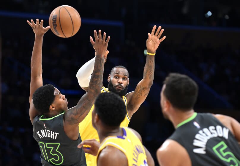 Los Angeles, California April 11, 2023-Lakers LeBron James passes the ball against the Timberwolves in the first quarter during a play-in game four the NBA playoffs at Crypto.com arena Tuesday. (Wally Skalij/Los Angeles Times)