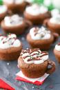 <p>You know what'll make these adorable treats taste even better? A massive mug of hot chocolate. </p><p>Get the <strong><a href="https://www.delish.com/cooking/recipe-ideas/recipes/a50247/hot-chocolate-cookie-cups-recipe/" rel="nofollow noopener" target="_blank" data-ylk="slk:Mini Hot Cocoa Brownie Cups recipe;elm:context_link;itc:0;sec:content-canvas" class="link ">Mini Hot Cocoa Brownie Cups recipe</a></strong> from Delish. </p>