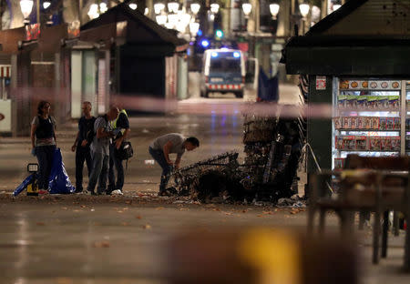 Forensic police officers search for clues near the area where a van crashed into pedestrians at Las Ramblas in Barcelona, Spain, August 18, 2017. REUTERS/Sergio Perez