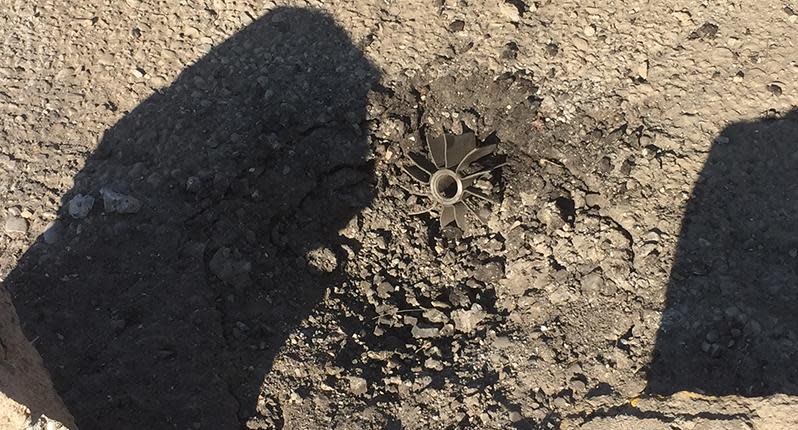 An unexploded mortar sits idle on the road