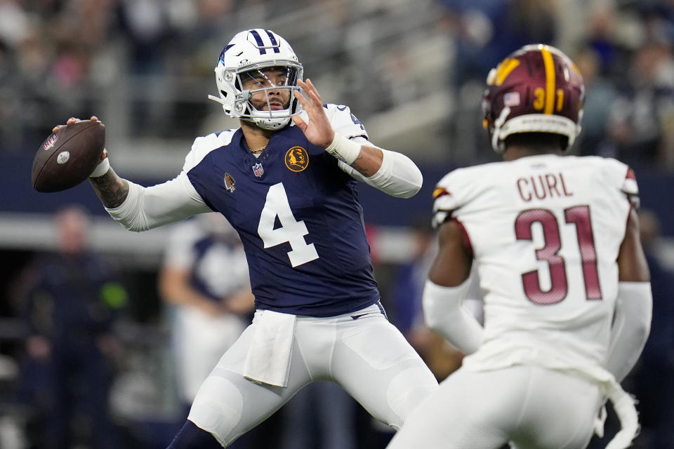 Dallas Cowboys quarterback Dak Prescott (4) passes against Washington Commanders safety Kamren Curl (31) during the first half of an NFL football game Thursday, Nov. 23, 2023, in Arlington, Texas. (AP Photo/Julio Cortez)