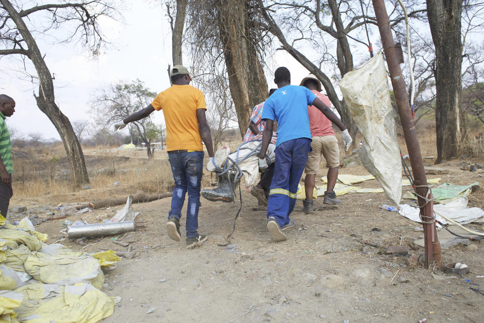 The body of a trapped miner is carried after been retrieved from a collapsed mine shaft in Chegutu, about 100 kilometers (60 miles) west of the capital Harare, Saturday, Sept. 30 2023. Several people have died from the collapse of a gold mine in Zimbabwe, according to state media reports. (AP Photo)