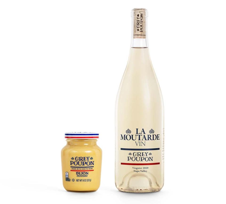 A bottle of Grey Poupon wine next to a jar of mustard