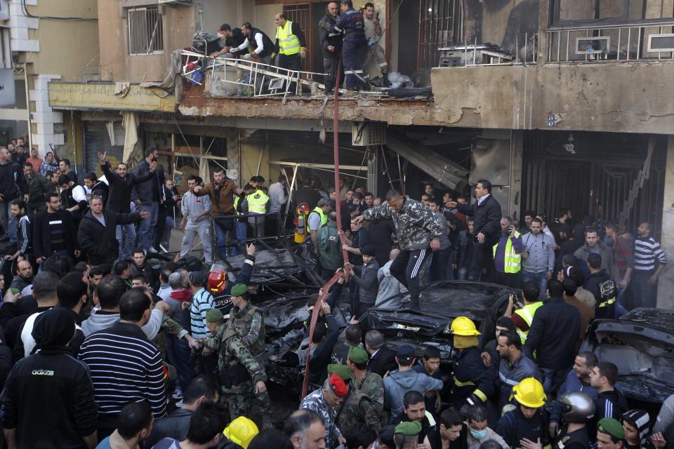 People gather at the site of a bomb blast in the Haret Hreik area, in the southern suburbs of the Lebanese capital Beirut