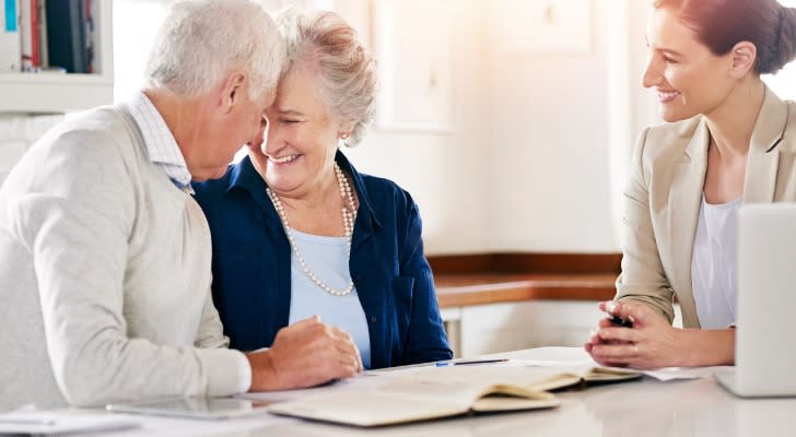 A senior couple consults a financial advisor about the rights of survivorship.