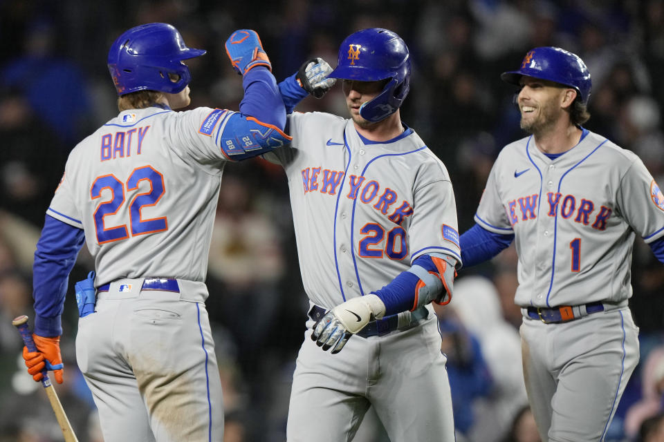 New York Mets' Pete Alonso, center, celebrates with Brett Baty, left, and Jeff McNeil after hitting a two-run home run against the Chicago Cubs during the seventh inning of a baseball game in Chicago, Thursday, May 25, 2023. (AP Photo/Nam Y. Huh)