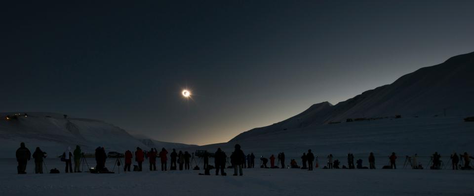 People view and photograph the March 20, 2015 total solar eclipse visible from a narrow strip of land on the archipelago of Svalbard, Norway.