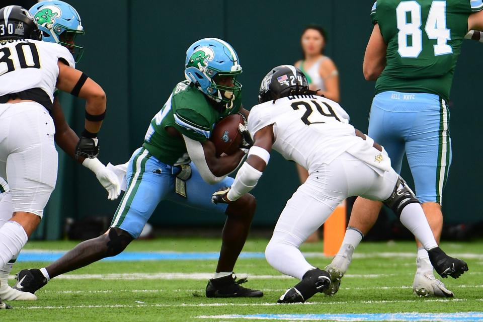Nov 12, 2022; New Orleans, Louisiana, USA; Tulane Green Wave running back Tyjae Spears (22) runs the ball past UCF Knights defensive back Jarvis Ware (24) during the first quarter at Yulman Stadium. Mandatory Credit: Rebecca Warren-USA TODAY Sports