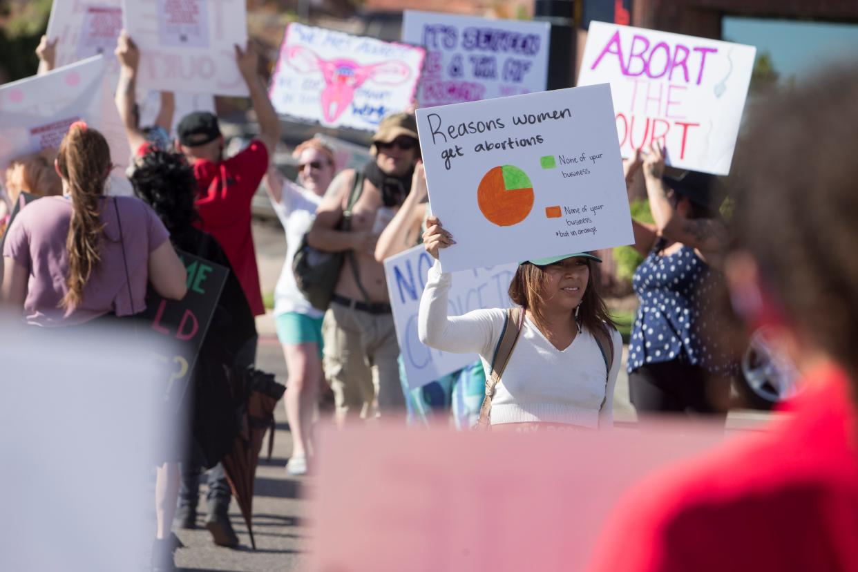 St. George residents protest the recent overturning of Roe v. Wade on St. George Blvd Friday, July 1, 2022. 