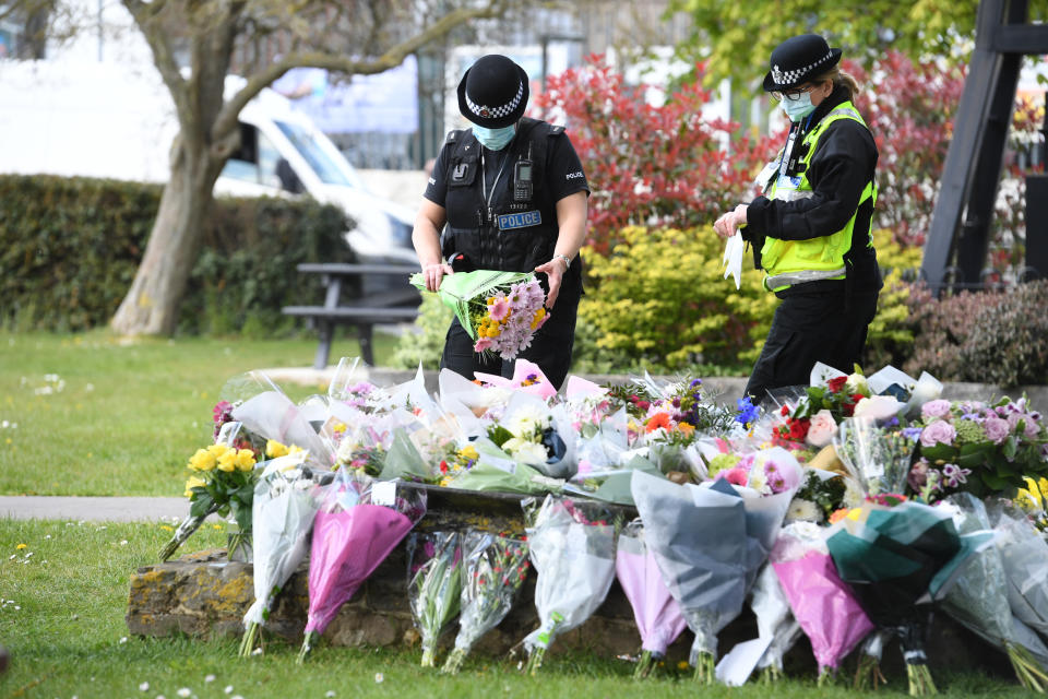 Two police officers lay floral tributes in a park in Aylesham village close to the scene in Snowdown, Kent, where the body of PCSO Julia James was found. Picture date: Saturday May 1, 2021.