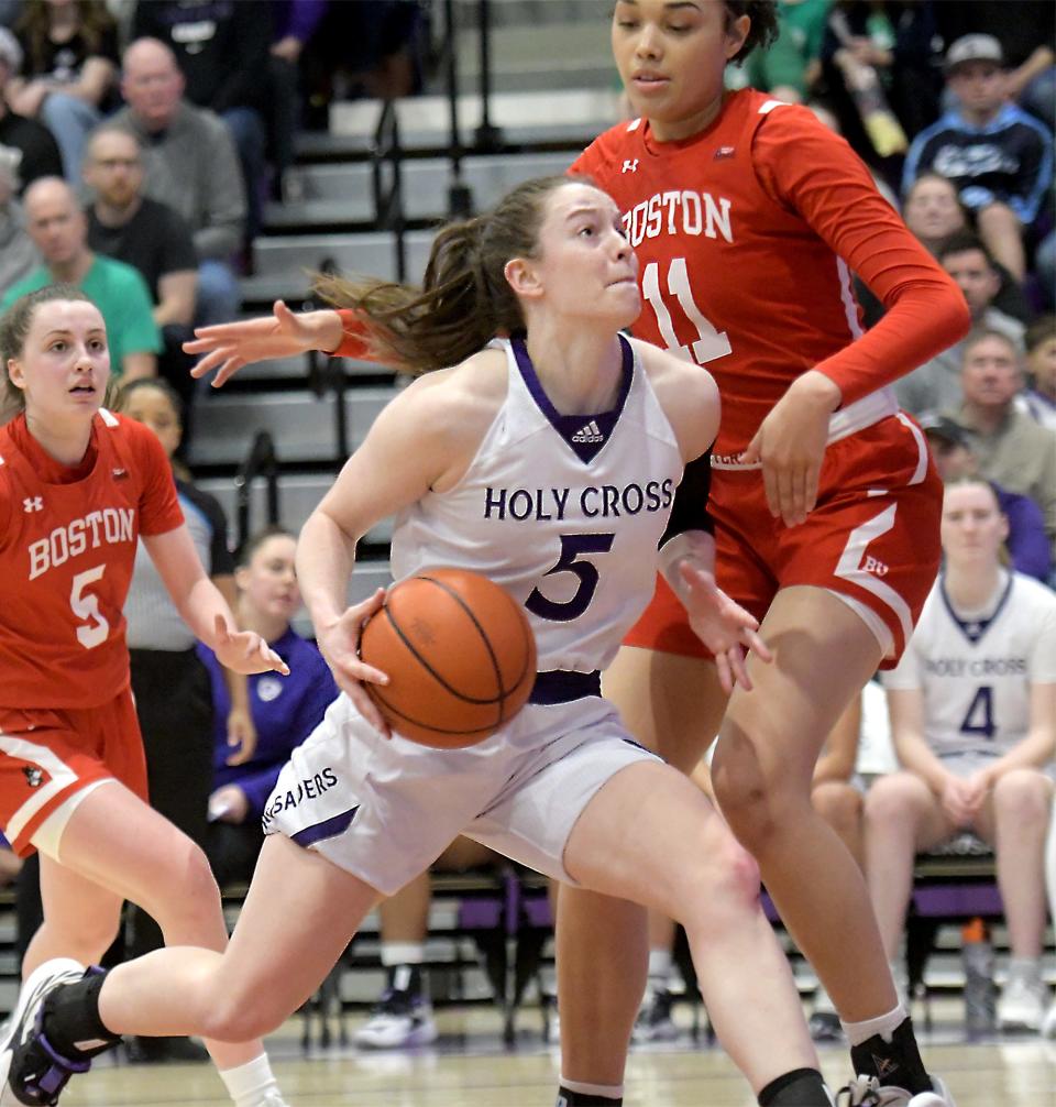 Holy Cross' Kaitlyn Flanagan drives to the hoop on Boston University's Caitlin Weimar during Sunday's Patriot League final.