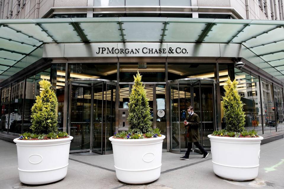 NEW YORK, NEW YORK - MARCH 17: A man walks in front JP Morgan office on March 17, 2021 in New York. JPMorgan Chase & Co is planning to have its  interns working from offices in London and New York City,  around June when the program begins but cautioned that the idea will depend on government guidance. (Photo by John Smith/VIEWpress via Getty Images)