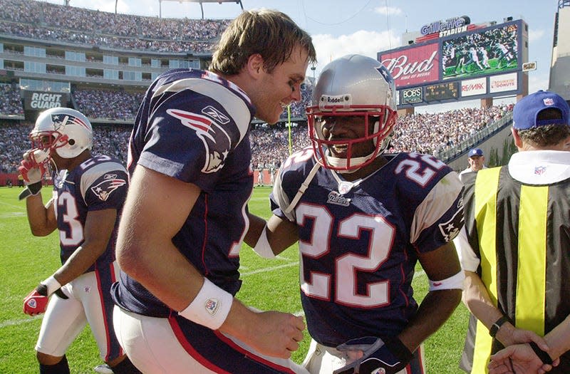 Cornerback Asante Samuel is congratulated by Tom Brady after his fourth quarter touchdown interception during a game in 2003.