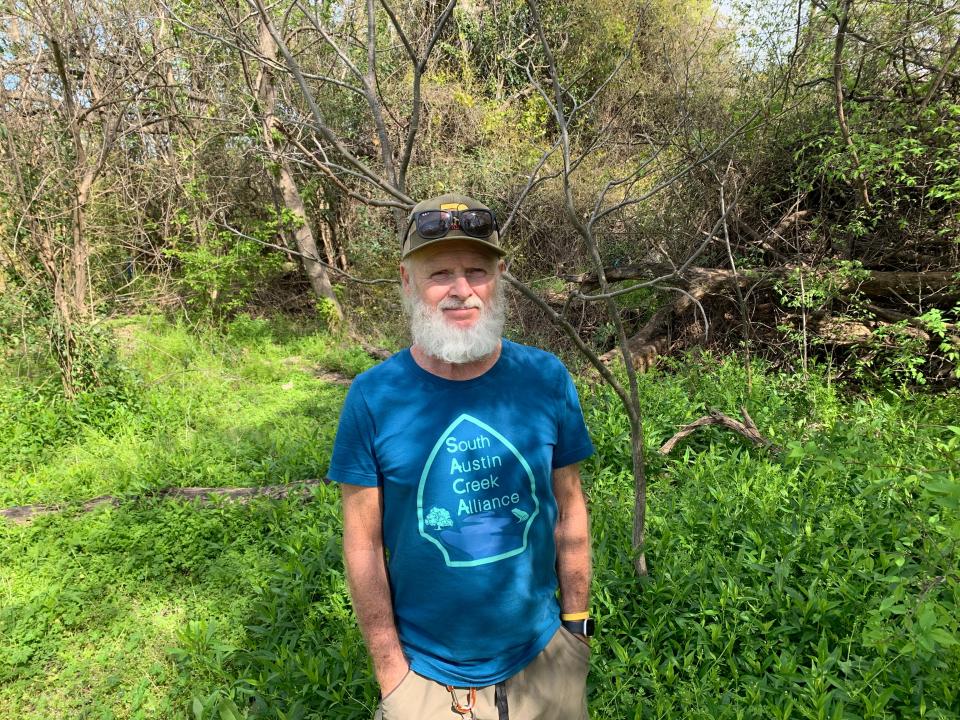 Richard Maness, who spends considerable time cleaning Williamson Creek in South Austin, stands in front of the brushy verges of Mystery Creek, which neighbors seek to save from oblivion.