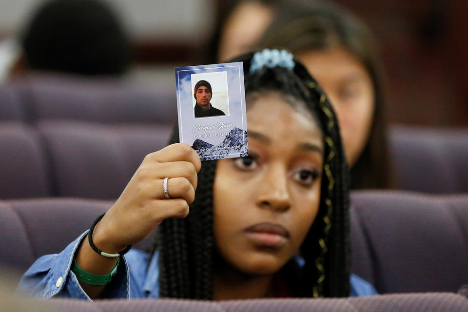 <p>Tyra Hemans, a senior from Marjory Stoneman Douglas (MSD) High School, holds a photo of her friend Joaquin Oliver, who died during last week’s mass shooting on her campus, as she and other MSD students speak with the leadership of the Florida Senate, at the Capitol in Tallahassee, Fla., Feb. 21, 2018. (Photo: Colin Hackley/Reuters) </p>