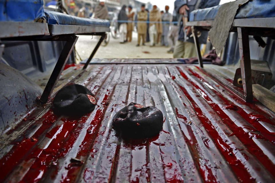 A police vehicle with blood stains and berets left in it at the site of a bomb explosion in Charsadda, Pakistan, Wednesday, Jan. 22, 2014. A bomb rigged to a bicycle struck a police patrol on its way to guard a polio vaccination team in northwestern Charsadda district, killing six, said officer Shafiullah Khan. (AP Photo/Mohammad Sajjad)