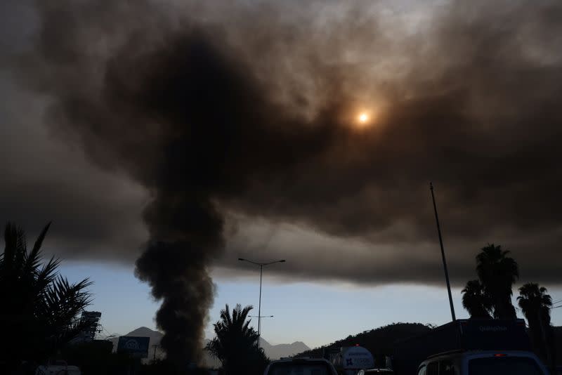 A smoke column rises from a fire in a factory in Santiago