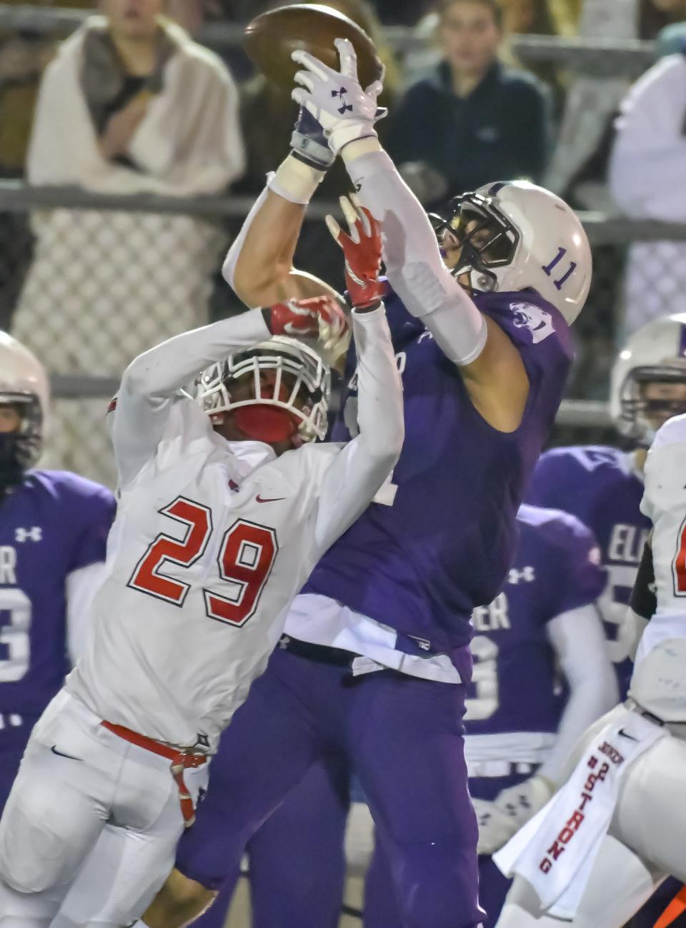 Joe Royer of the Elder Panthers catches the ball over Kenny Willis the Colerain Cardinals during the OHSAA Region 4 Final on Friday, November 22, 2019 at Atrium Stadium, Mason, Ohio. The two are now teammates as Royer transferred from Ohio State to UC where Willis is a member of the Bearcat defense.