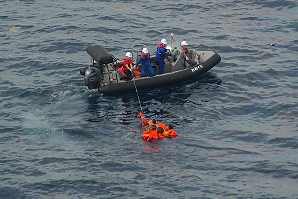 In this Monday, Oct. 7, 2019, photo released by the 9th Regional Japan Coast Guard Headquarters, crew of a Japanese Fisheries Agency patrol vessel work to rescue North Korean fishermen off the northwestern coast of the Noto Peninsula, Ishikawa prefecture, Japan. Japanese authorities said they rescued all of about 60 North Korean fishermen whose boat collided with a Japanese patrol vessel and sank Monday in an area crowded with poachers. (The 9th Regional Japan Coast Guard Headquarters via AP)