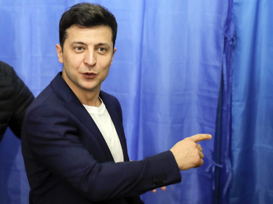 Ukrainian comedian and presidential candidate Volodymyr Zelenskiy gestures at a polling station, during the second round of presidential elections in Kiev, Ukraine, Sunday, April 21, 2019. Top issues in the election have been corruption, the economy and how to end the conflict with Russia-backed rebels in eastern Ukraine. (AP Photo/Vadim Ghirda)