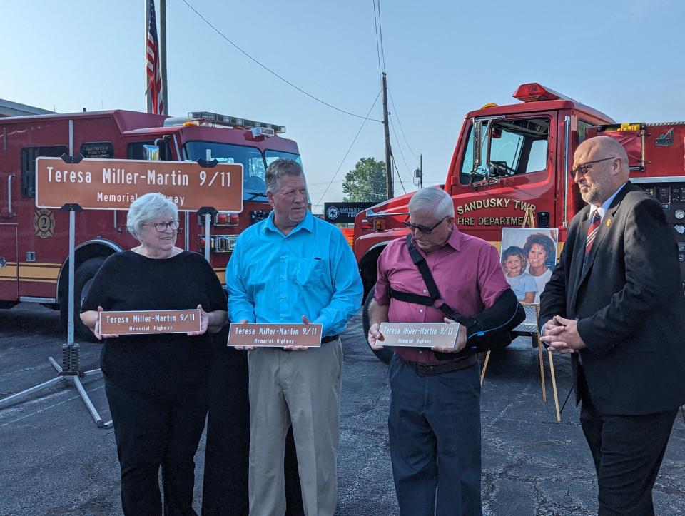 State Rep. Gary Click, R-Vickery, right, presents the family of Teresa Miller-Martin with copies of the new sign for the renamed section of Ohio 19 that was named in honor of their sister, from left are Susan DeGrie, Dan and David Miller.