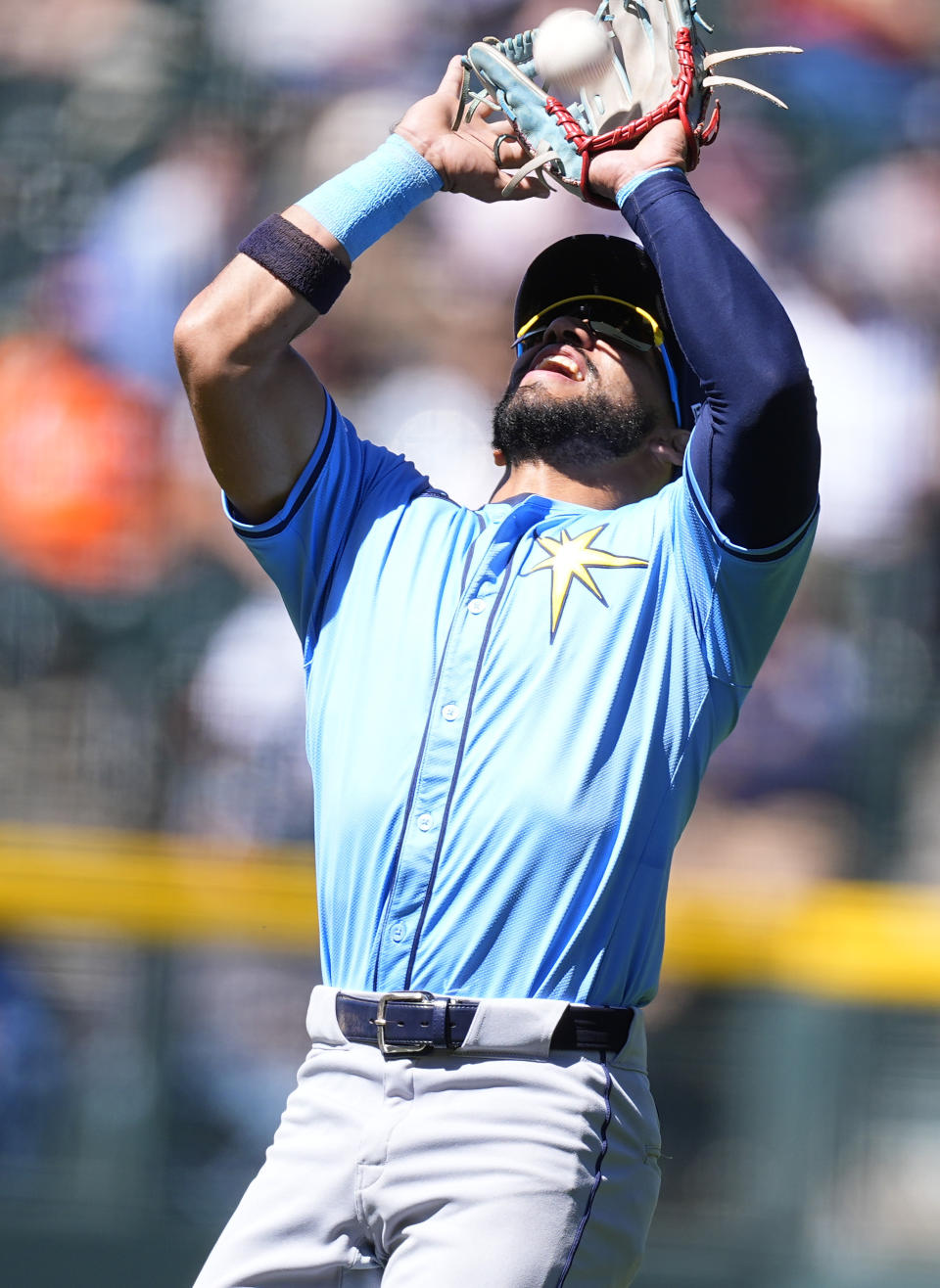 Tampa Bay Rays shortstop José Caballero pulls in a pop fly off the bat of Colorado Rockies' Charlie Blackmon to end the third inning of a baseball game Sunday, April 7, 2024, in Denver. (AP Photo/David Zalubowski)