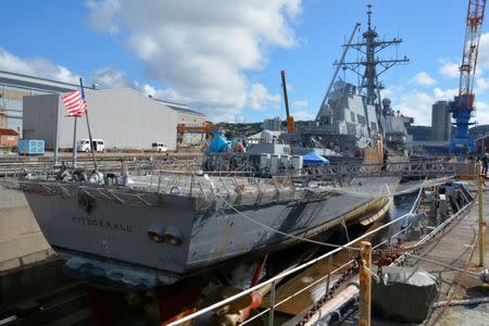 The Arleigh Burke-class guided-missile destroyer USS Fitzgerald (DDG 62) sits in Dry Dock 4 for continued repairs and assessment of damage it sustained during its June 17, 2017 collision with a merchant vessel at Fleet Activities (FLEACT) Yokosuka in Yokosuka, Japan in this photo taken July 11, 2017. Courtesy of U.S. Navy/Mass Communication Specialist 2nd Class Leonard Adams/Handout via REUTERS