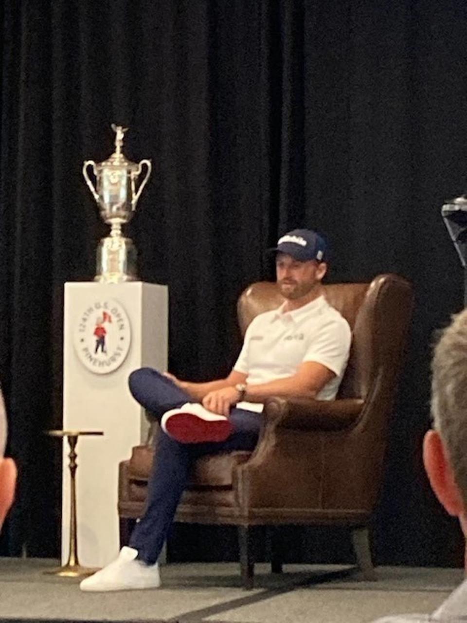 Wyndham Clark, the 2023 US Open champion, sits next to championship trophy at a media day outing at Pinehurst on May 6, 2024. Chip Alexander