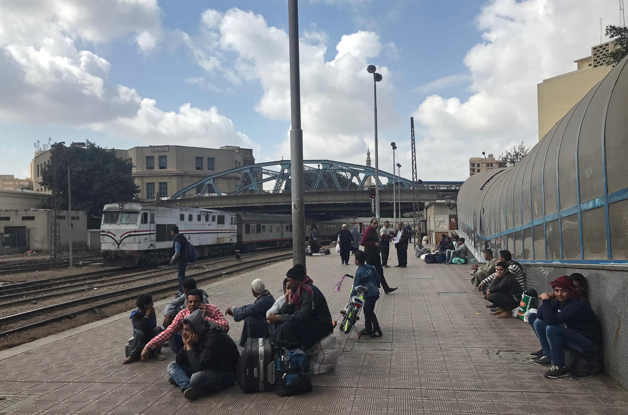  People sit on a platform after a fire caused deaths and injuries at the main train station in Cairo. (REUTERS/Amr Abdallah Dalsh)