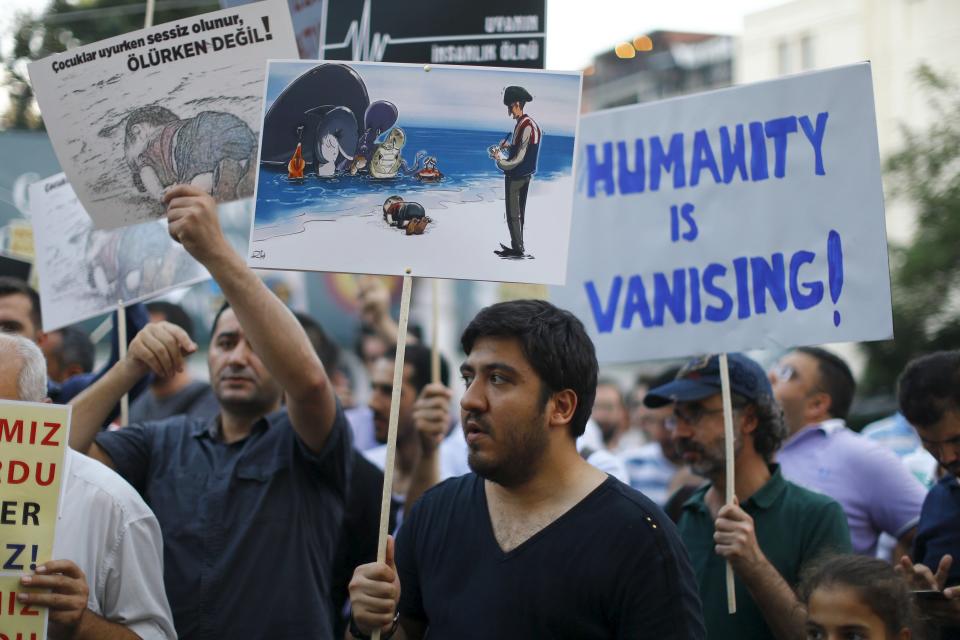 People hold posters with drawings depicting a drowned Syrian toddler during a demonstration for refugee rights in Istanbul, Turkey, September 3, 2015. The distraught father of two Syrian toddlers who drowned with their mother and several other migrants as they tried to reach Greece identified their bodies on Thursday and prepared to take them back to their home town of Kobani. Abdullah Kurdi collapsed in tears after emerging from a morgue in the city of Mugla near Bodrum, where the body of his three-year old son Aylan washed up on Wednesday. The image of Aylan, drowned off one of Turkey's most popular holiday resorts, went viral on social media and piled pressure on European leaders. Abdullah's family had been trying to emigrate to Canada after fleeing the war-torn town of Kobani, a revelation which also put Canada's Conservative government under fire from its political opponents. REUTERS/Osman Orsal