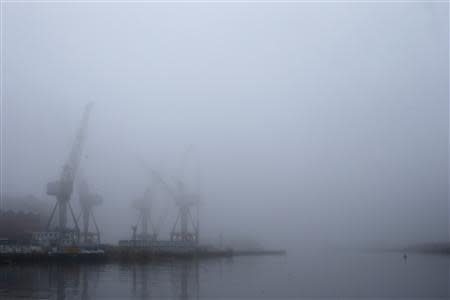 Cranes are seen at BAE Systems Govan yard during a misty morning in Glasgow, Scotland January 14, 2014. REUTERS/Stefan Wermuth