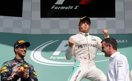 Belgium Formula One - F1 - Belgian Grand Prix 2016 - Francorchamps, Belgium - 28/8/16 - Mercedes' Nico Rosberg of Germany celebrates on the podium with Red Bull's Daniel Ricciardo of Australia after the Belgian F1 Grand Prix. REUTERS/Yves Herman