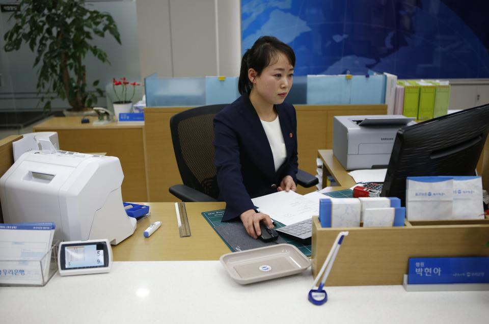 A North Korean employee works in a bank at the Joint Industrial Park in Kaesong industrial zone, a few miles inside North Korea from the heavily fortified border December 19, 2013. Kaesong, with investors from South Korea, was a rare source of hard currency for North Korea. It was established even though North Korea is technically still at war with South Korea, one of the world's richest countries, since the 1950-53 Korean War ended not in a treaty but a truce. Since it opened in 2004, the Kaesong complex has generated about $90 million annually in wages paid directly to the North's state agency that manages the zone. REUTERS/Kim Hong-Ji (NORTH KOREA - Tags: POLITICS BUSINESS EMPLOYMENT)