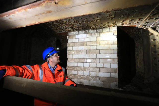 Undated handout photo issued by Network Rail of Greg Thornett, Project Manager, looking at the remains of Southwark Park station, a "ghost" station that closed a century ago, which has been uncovered during work on a ï¿½6.5 billion rail project. PRESS ASSOCIATION Photo. Issue date: Monday April 20, 2015. Southwark Park station in south London only served passengers from 1902 to 1915 before shutting for good. But now engineers constructing the Bermondsey Dive Under as part of the Thameslink Programme have rediscovered the former ticket hall and platforms. See PA story RAIL Ghost. Photo credit should read: Network Rail/PA WireNOTE TO EDITORS: This handout photo may only be used in for editorial reporting purposes for the contemporaneous illustration of events, things or the people in the image or facts mentioned in the caption. Reuse of the picture may require further permission from the copyright holder.