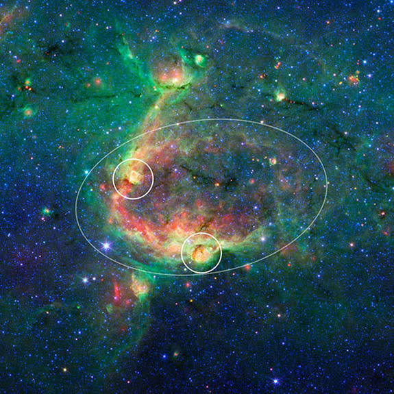 This infrared image shows a striking example of what is called a hierarchical bubble structure, in which one giant cosmic bubble, carved into the dust of space by massive stars, has triggered the formation of smaller bubbles.