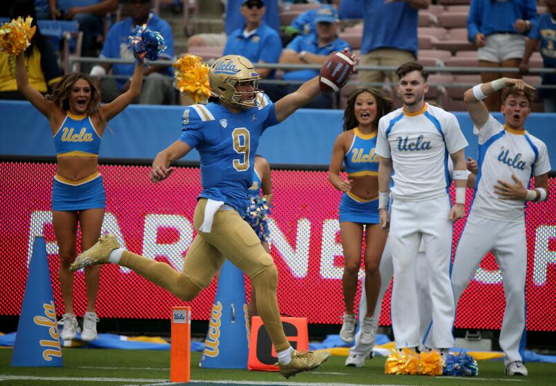Pasadena, CA - UCLA quarterback Collin Schlee evades a tackle by North Carolina Central.