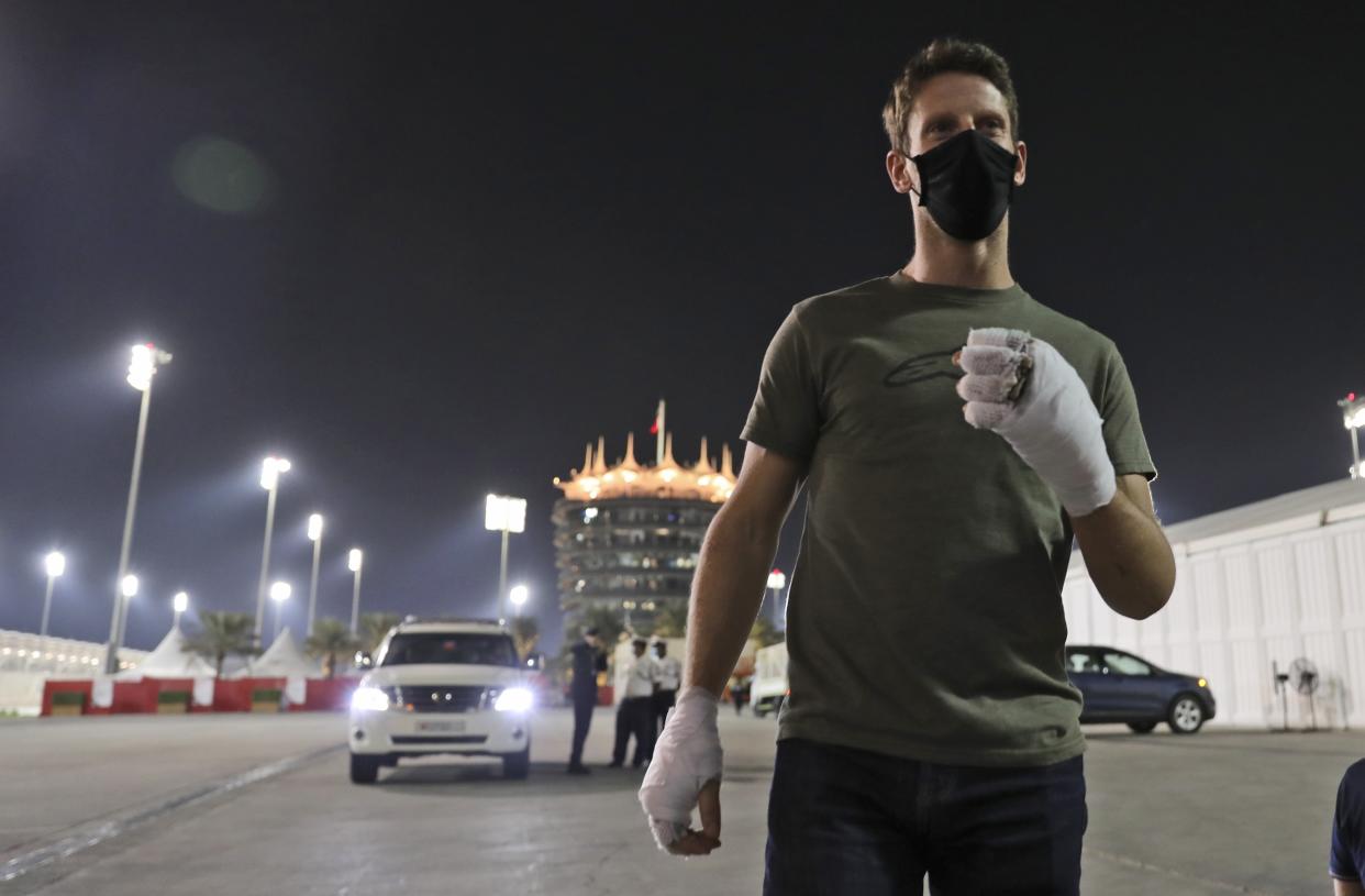 Haas driver Romain Grosjean of France arrives to to thank the marshals Thursday, Dec. 3, 2020, at Bahrain International Circuit in Sakhir, Bahrain.  Grosjean escaped with only minor burns when his Haas car exploded into a fireball after crashing on the first lap at last weekend's Bahrain GP. (AP Photo/Kamran Jebreili)