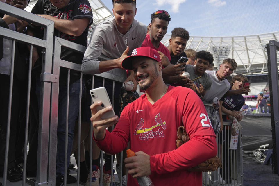 St. Louis Cardinals' Nolan Arenado takes a selfie with supporters during a training session ahead of the baseball match against Chicago Cubs at the MLB World Tour London Series, in London Stadium. (AP Photo/Kin Cheung)