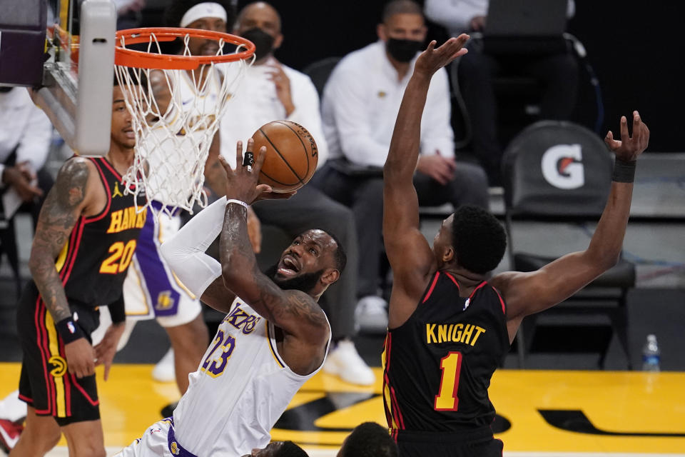 Los Angeles Lakers forward LeBron James (23) drives to the basket past Atlanta Hawks forward Nathan Knight (1) during the first half of an NBA basketball game Saturday, March 20, 2021, in Los Angeles. (AP Photo/Marcio Jose Sanchez)