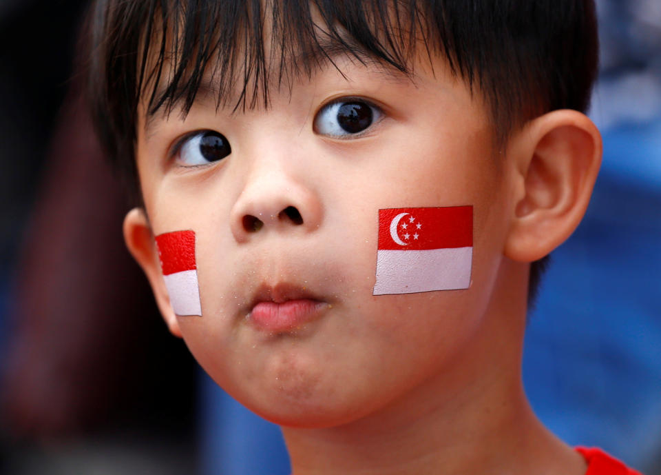 A young boy, face painted with national flag is seen during Singapore's 54th National Day Parade in Singapore August 9, 2019. REUTERS/Feline Lim