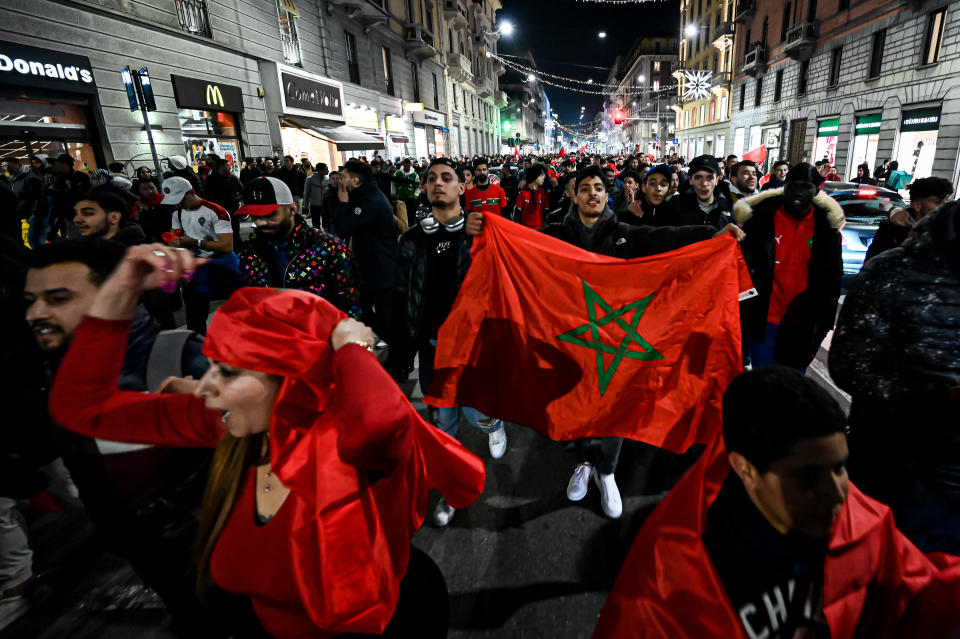 MILAN, ITALY - DECEMBER 6: Supporters of Morocco celebrate in Corso Buenos Aires after Morocco qualified for the quarter finals of the FIFA World Cup 2022 by eliminating Spain on penalties in Milan, Italy on December 6, 2022 (Photo by Piero Cruciatti/Anadolu Agency via Getty Images)
