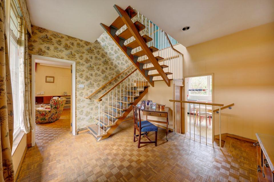 A flying staircase connects the two floors of the main house (Savills)