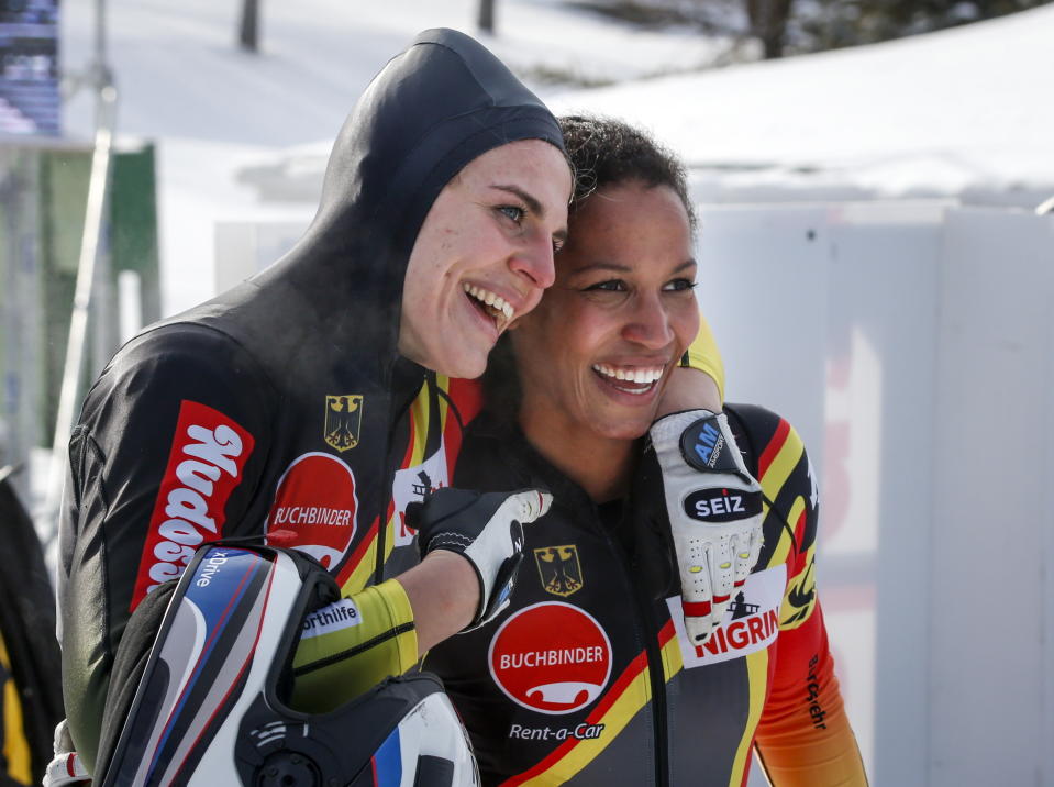 Germany's Mariama Jamanka, right, and Annika Drazeky, celebrate their victory in the women's World Cup boblsed event in Calgary, Alberta, Saturday, Feb. 23, 2019. (Jeff McIntosh/The Canadian Press via AP)