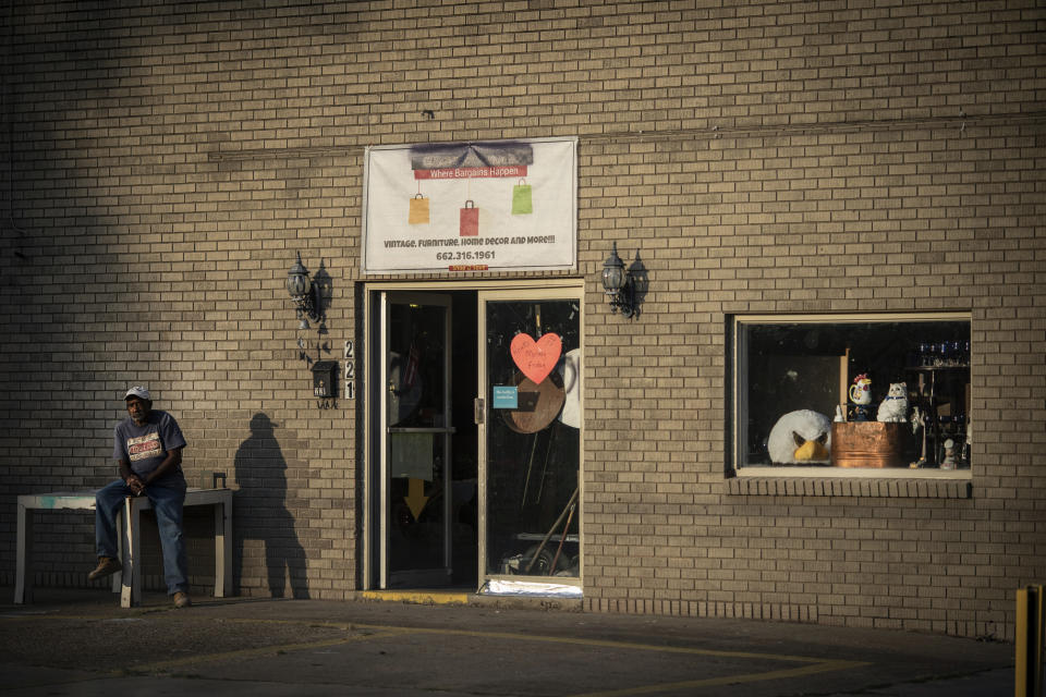 A man sits outside a store selling vintage furniture and home decorations in Meridian Miss., Tuesday, Oct. 6, 2020. Today, voters in Mississippi face a series of government-created barriers that make it, according to a study in the Election Law Journal in 2018, far and away the most difficult state in which to vote. (AP Photo/Wong Maye-E)