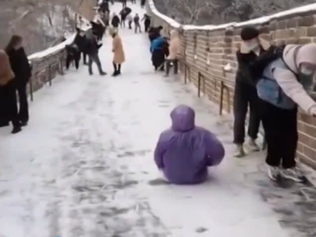 Tourist uses Great Wall as a slide (Youtube/Accuweather)