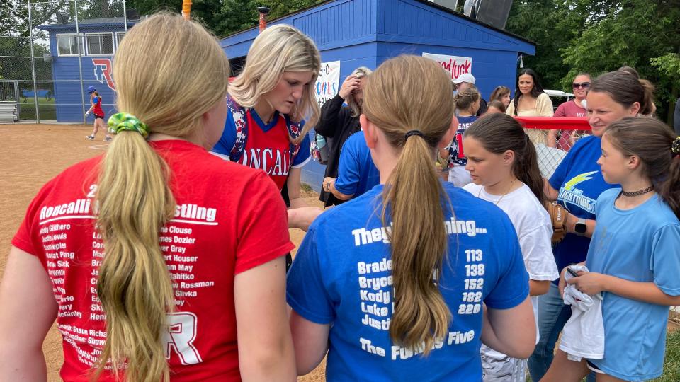 Roncalli junior pitcher Keagan Rothrock signs autographs after being named Gatorade National Softball Player of the Year on Wednesday, June 8, 2022.