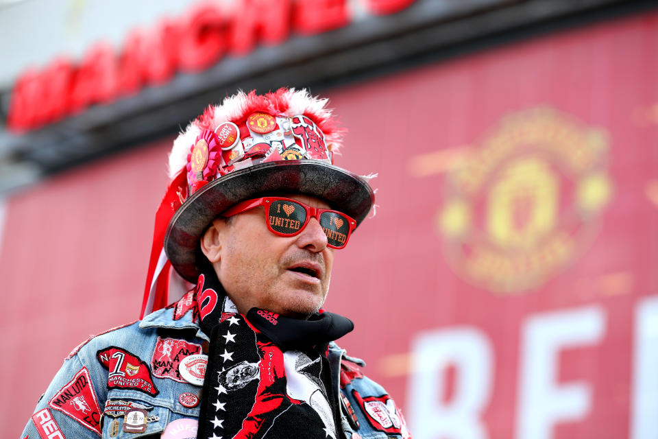 <p>A Manchester United fan arrives at the stadium before the Premier League match at Old Trafford, Manchester. Picture date: Tuesday May 18, 2021.</p>
